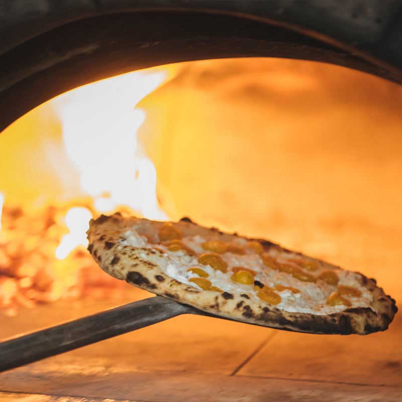 pizza going into fire oven Live Fire Pizza Oxbow Public Market Napa